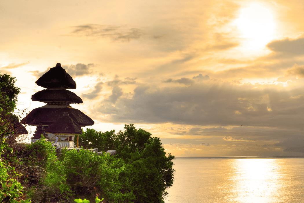 The iconic Ulun Danu Beratan water temple in Bali reflecting on a still lake.