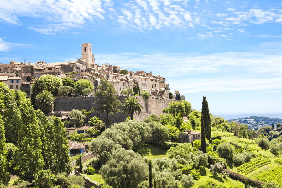 Medieval village of Saint-Paul-de-Vence in the French Riviera, characterized by a cluster of stone buildings and a prominent central bell tower.